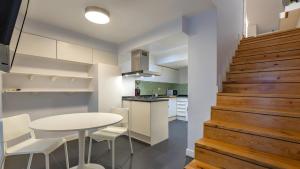 a kitchen and dining room with a white table and chairs at Lisbon Fancy Duplex W/ Patio by LovelyStay in Lisbon
