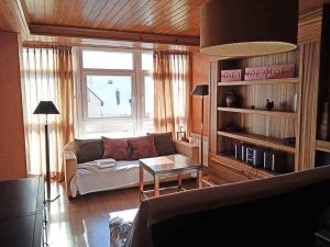a living room with a couch and a table at Apartamentos Candanchu 3000 in Candanchú