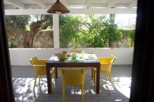 a dining table and chairs on a patio at Villa Federica in Pizzolungo