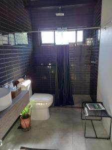 a bathroom with a toilet and a sink and a shower at Pousada IMcasa 430 in Bento Gonçalves