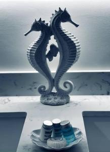 two seahorses sitting on a table with a plate at Luxury Smart Home in the Heart of Cape Coral in Cape Coral