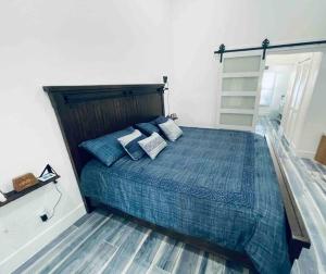 ein Schlafzimmer mit einem großen Bett mit blauen Kissen in der Unterkunft Luxury Smart Home in the Heart of Cape Coral in Cape Coral