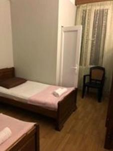 a small room with a bed and a chair at Mака и Сулико in Batumi