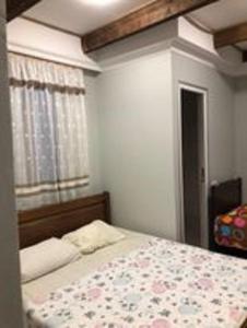 a bedroom with a bed with a floral bedspread at Mака и Сулико in Batumi