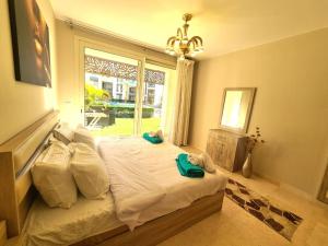 a bedroom with a large bed with a window at Fabulous Sea view 1 BR & private Garden to the pool at Mangroovy in Hurghada +43 photos