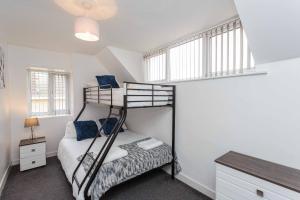 a bedroom with two bunk beds and a desk at Cherry Property - Blueberry Suite in Blackpool