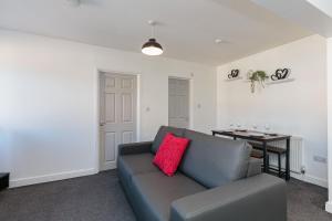 a living room with a couch and a table at Cherry Property - Cranberry Suite in Blackpool