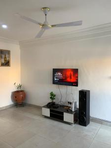 a living room with a flat screen tv on the wall at CRL Apartment 1 in Tema