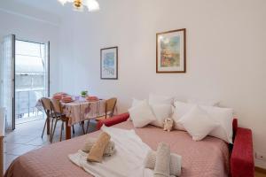 a bedroom with a bed with a table and a dining room at Appartamento Centrale - sulla pedonale in Dolceacqua +13 photos