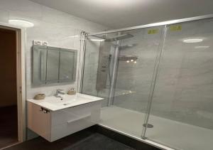 a bathroom with a shower and a sink and a glass shower stall at Love Room O'Dream, Jacuzzi et Lit King Size in Fleury-les-Aubrais +3 photos