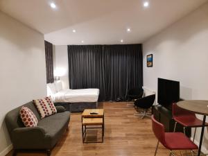 a living room with a couch and a bed at VCity ApartHotels Glasgow Central in Glasgow