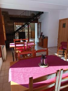 a dining room with a table with a purple table cloth at Hotel D` Ares in Ares del Maestre