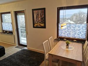 a dining room with a table and chairs and a window at Ferienhaus Lichtenberg in Herleshausen