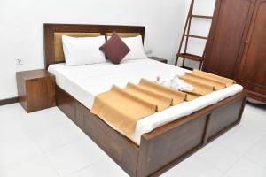 a bedroom with a large bed with a ladder at Urban Deck in Colombo