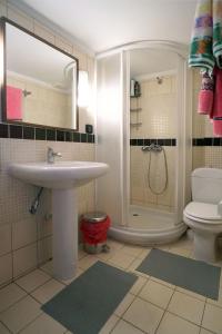 a bathroom with a sink and a shower and a toilet at Solon and Teo Summer House in Avdira beach in Paralía Avdhíron