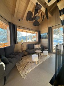 a living room with a couch and a table at Chalet neuf La Perle du Perron in Cordon