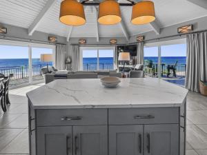 a kitchen and living room with a view of the ocean at Nifty Shades Of Gray Home in Inlet Beach