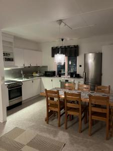 a kitchen with a large wooden table and chairs at Big Apartment in central Kiruna 5 in Kiruna