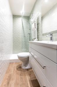 a white bathroom with a toilet and a sink at FRGK " Charming Studio in Historic Center of Cannes" in Cannes
