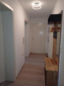 a hallway with white walls and a wooden floor at Ferienwohnung-Nüsttal in Nüsttal