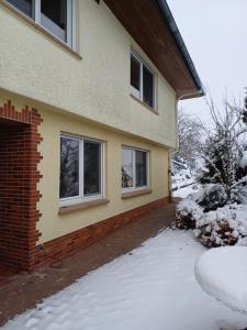 a house with snow in front of it at Ferienwohnung-Nüsttal in Nüsttal