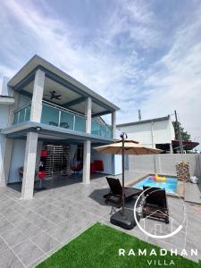 uma casa com um pátio e uma piscina em Ramadhan Villa PD em Porto Dickson