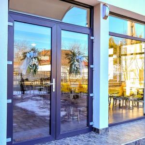 an open door to a patio with tables and chairs at Casa Mara in Ocna Şugatag