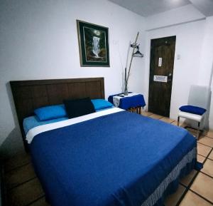 Rúm í herbergi á Hotel Cocos