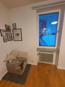 a living room with a couch and a window at Close to the subway. Beautiful and Cozy apartment! in Stockholm
