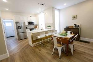 a kitchen and dining room with a table and chairs at Cozy Modern 3 bedroom Home in west Philly in Philadelphia