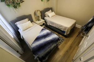 a bedroom with two beds and a window at Cozy Modern 3 bedroom Home in west Philly in Philadelphia