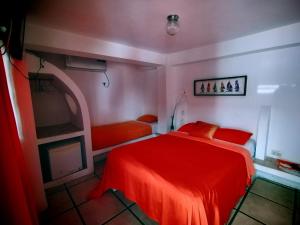 Rúm í herbergi á Hotel Cocos