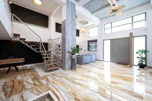 a lobby with a marble floor and a staircase at La Casa Kos Center with Jacuzzi in Kos