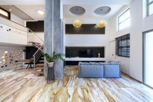 a living room with a fireplace and a blue couch at La Casa Kos Center with Jacuzzi in Kos