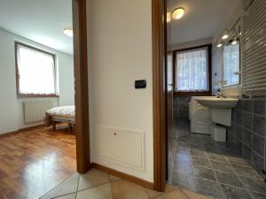 a bathroom with a shower and a sink and a mirror at 058 Trilocale Baldino, Pinzolo in Pinzolo +13 photos