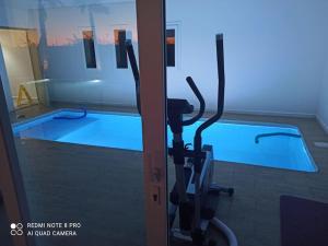 a gym with a swimming pool in the background at Bienvenu chez VillAtlas in Marrakech