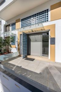 a facade of a building with a glass door at La Casa Kos Center with Jacuzzi in Kos Town
