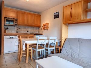 kuchnia ze stołem i krzesłami w kuchni w obiekcie Charmant appartement 3 pièces, terrasse, ski à proximité - FR-1-425-135 w mieście Flaine