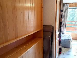 a room with wood paneling and a room with a window at Studio Flaine, 1 pièce, 4 personnes - FR-1-425-204 in Arâches-la-Frasse