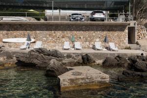 a group of chairs and a pool of water at House Rasica in Molunat