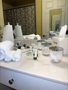 a bathroom counter with towels and a mirror at Luxury Miami 2br Townhouse Near Stadium !! in Miami Gardens