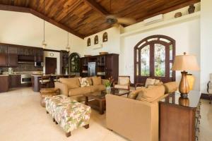 a large living room with couches and a table at Casa Cinco Sinsontes in Playa Hermosa