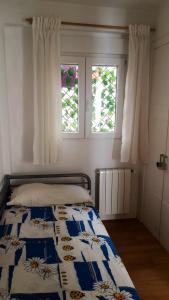 a bedroom with a bed with a blue and white quilt at 3 bedrooms appartement with wifi at Valencia 3 km away from the beach in Valencia