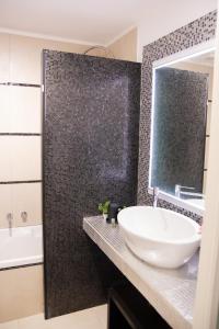 a bathroom with a white sink and a shower at Home Rent Mancini in Rome