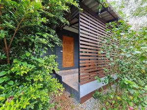 a small blue house with a wooden door in a garden at Koh Mak Littel House in Ko Mak