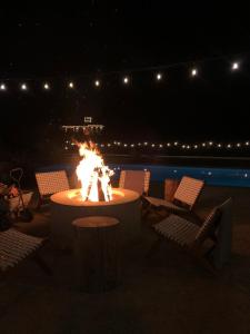 a fire pit in the middle of a patio at night at Black Barn Ranch 25 Acres Wpool Near Downtown in San Luis Obispo