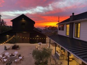 a house with a patio with a sunset in the background at Black Barn Ranch 25 Acres Wpool Near Downtown in San Luis Obispo