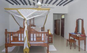 a bedroom with two beds and a ceiling fan at Pearl Beach by Sansi in Michamvi
