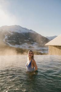 a woman standing in a body of water at QC Hotel Bagni Vecchi in Bormio