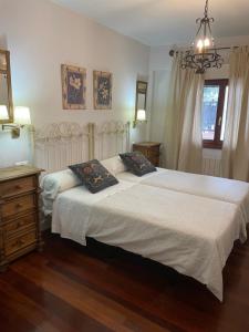 a bedroom with a bed with two pillows on it at Hotel Kaia in Ciérvana